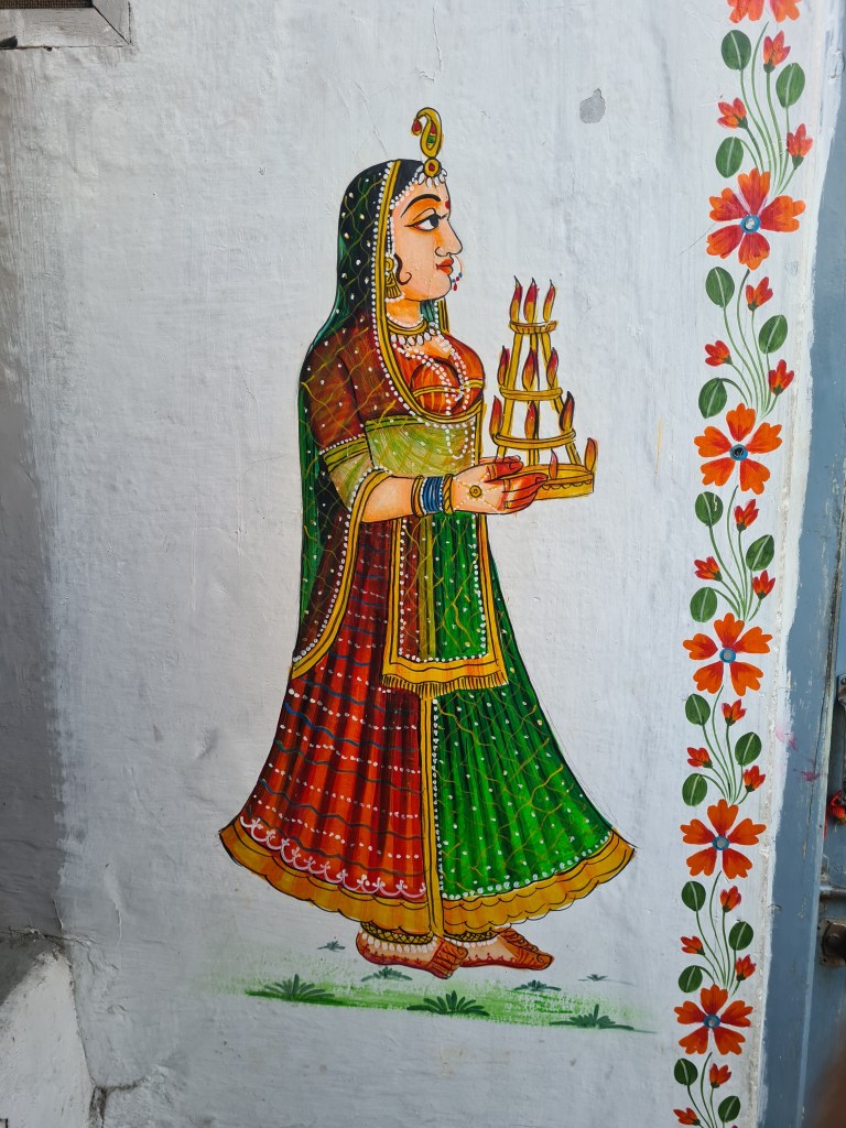 Doorway painting of a woman with candles