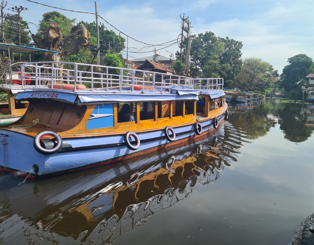 Reflections of a blue boat in calm waters