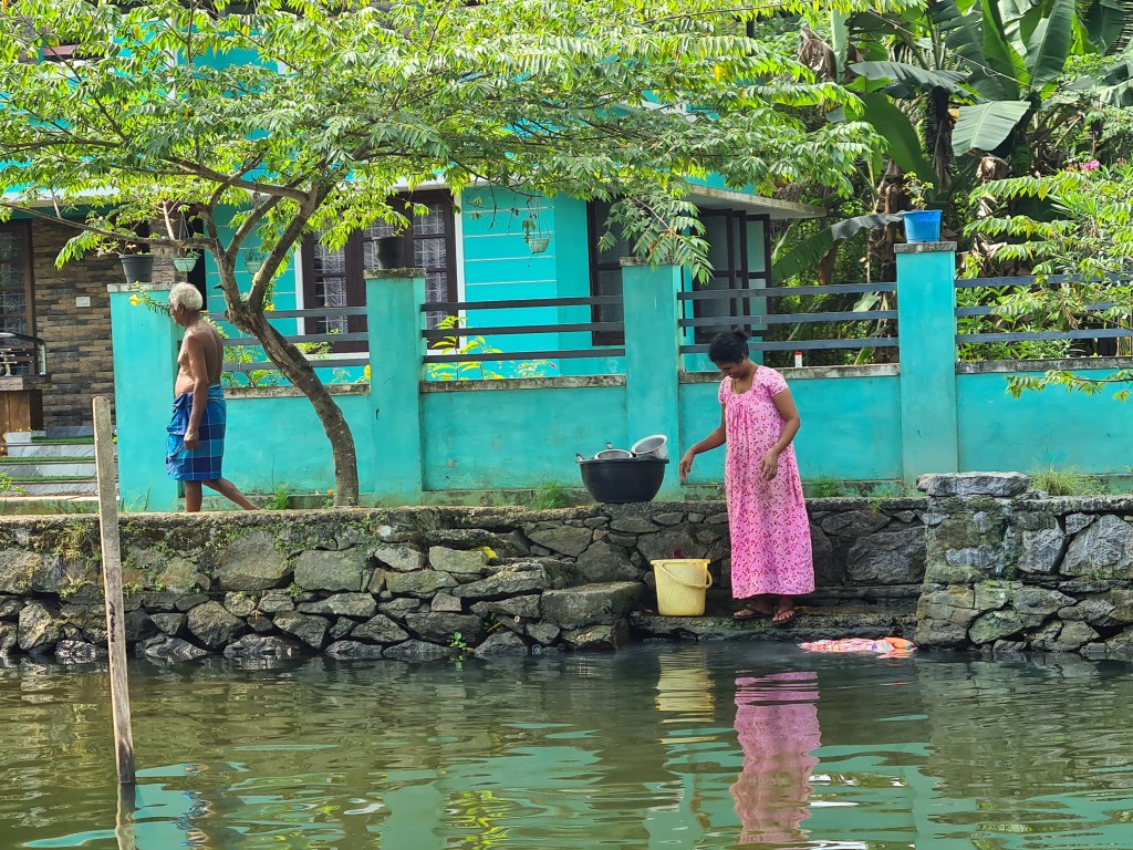 Woman in pink doing washing