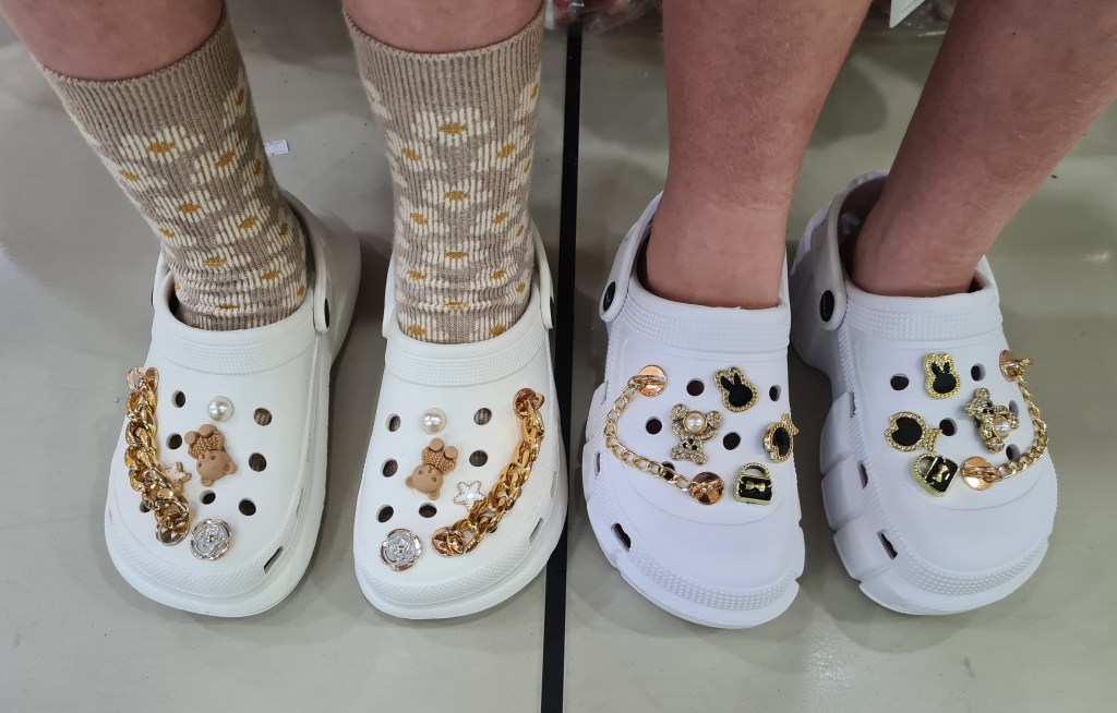 Two pairs of crocs with bling decorations
